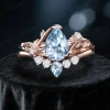Nature-inspired aquamarine and alexandrite engagement ring and wedding band set in rose gold