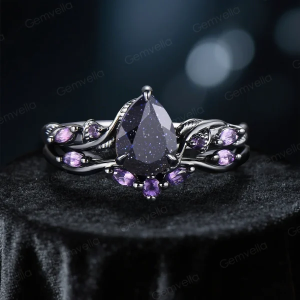 Nature-inspired engagement ring with pear-cut galaxy blue sandstone and amethyst, in black gold vine band.