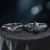 Close-up of pear-cut galaxy blue sandstone engagement ring with black gold vine setting