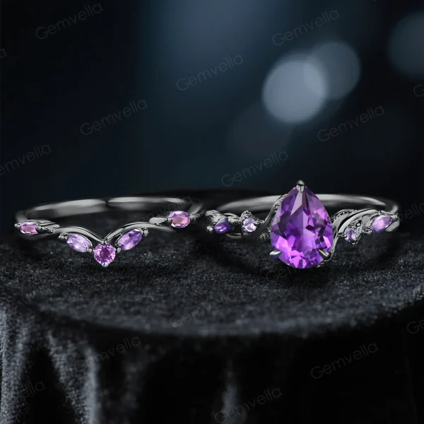 Close-up of pear-cut galaxy blue sandstone engagement ring with black gold vine setting
