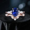 Front view of 1.5ct oval Blue Sapphire and marquise moissanite cluster engagement ring set in 10k rose gold