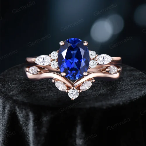 Front view of 1.5ct oval Blue Sapphire and marquise moissanite cluster engagement ring set in 10k rose gold