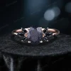 front view of 1.5 carat oval cut blue sandstone engagement ring with galaxy starry sky cluster design and black gemstone accents