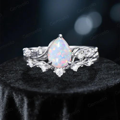 Front view of 1.25ct pear cut opal engagement ring set with sterling silver nature inspired twig vine and leaf design, showcasing the pear shaped opal center stone and delicate metalwork details