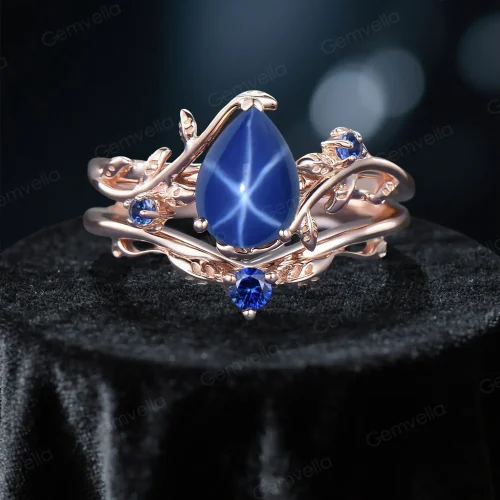 Front view of the 1.25ct natural star sapphire ring set featuring a pear-cut blue sapphire center stone surrounded by nature-inspired leaf and branch motifs.