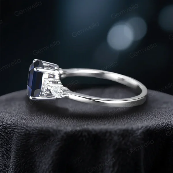 Side profile showing the detailed setting and height of the oval blue sapphire and marquise moissanite stone on this handmade bridal ring.