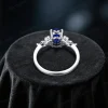 Top down view highlighting the brilliant cut of the center oval blue sapphire and the surrounding marquise moissanite halo design.
