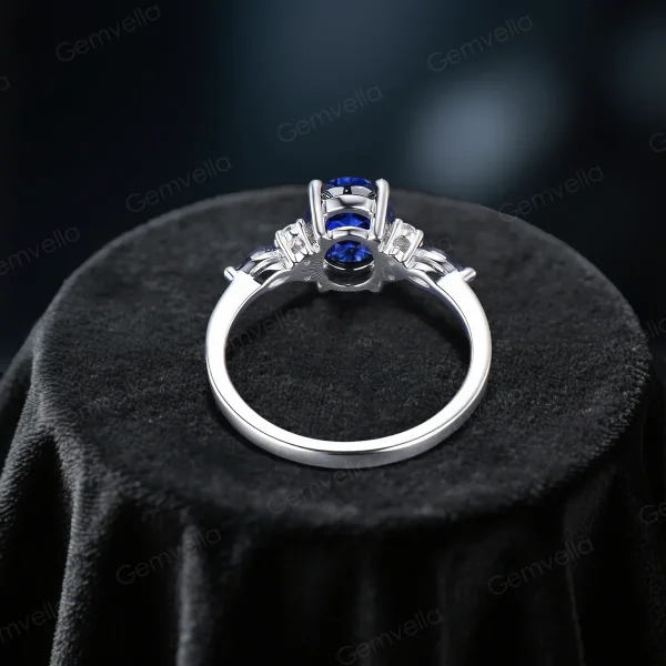 Top down view highlighting the brilliant cut of the center oval blue sapphire and the surrounding marquise moissanite halo design.