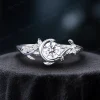 A sparkling 925 sterling silver moissanite ring, highlighting the bright silver finish contrasting with the nature-inspired dainty leaf and vintage moon star setting.