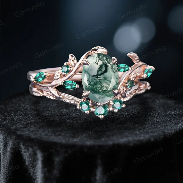 Angled view of the nature inspired moss agate and emerald bridal set, highlighting the 10k rose gold leaf vine design and oval cut gemstones.