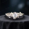 Side profile of a classic yellow gold engagement ring showcasing a brilliant 1ct round moissanite stone, detailed with a vintage celestial moon star design and delicate leaf textures.
