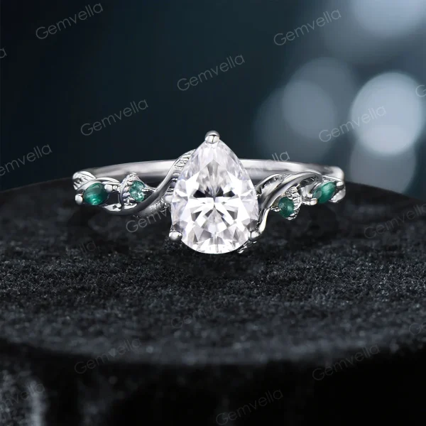 Front view of the main pear cut moissanite engagement ring from the vintage nature inspired set, featuring an intricate twig vine band with leaf details and a brilliant pear shaped center stone.