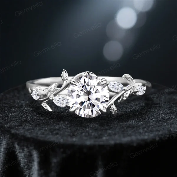 Vintage sterling silver moissanite engagement ring featuring a round cut diamond alternative gemstone and delicate leaf vine nature inspired setting, showcasing the alternative metal option for bridal ring design