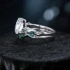 Side view of the vintage twig vine moissanite ring set, highlighting the organic branch and leaf motif wrapping around the band and the profile of the pear and emerald cut stones.
