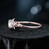 Side profile view of a rose gold moissanite engagement ring highlighting the leaf vine nature inspired band thickness, setting height and vintage bridal ring silhouette with diamond alternative gemstone