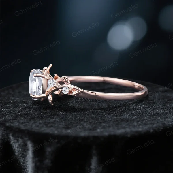 Side profile view of a rose gold moissanite engagement ring highlighting the leaf vine nature inspired band thickness, setting height and vintage bridal ring silhouette with diamond alternative gemstone