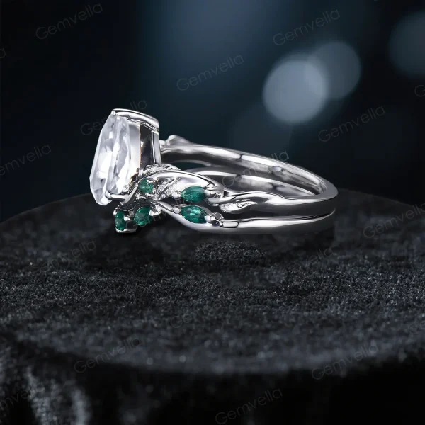 Side view of the vintage twig vine moissanite ring set, highlighting the organic branch and leaf motif wrapping around the band and the profile of the pear and emerald cut stones.