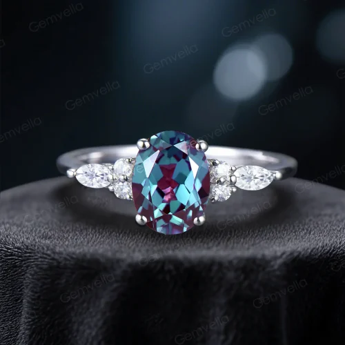 Front view of a handcrafted vintage bridal set showcasing a 1.5ct oval color-change alexandrite center stone with a halo of marquise cut moissanite accents on a detailed band.