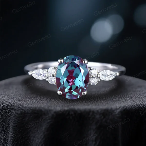 Front view of a handcrafted vintage bridal set showcasing a 1.5ct oval color-change alexandrite center stone with a halo of marquise cut moissanite accents on a detailed band.