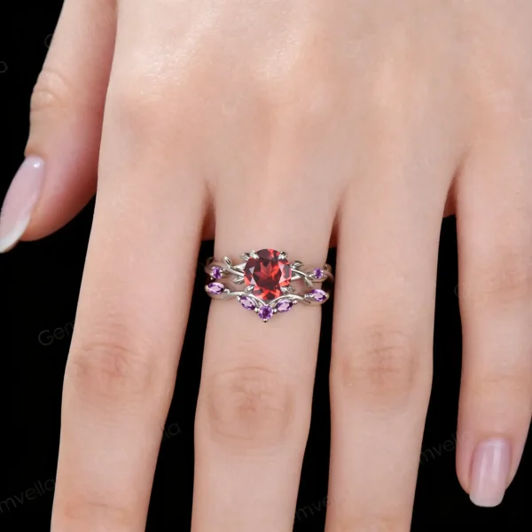 Lifestyle close-up of the vintage Red Garnet and Amethyst ring set worn on a woman's finger, demonstrating how the twisting vine design wraps elegantly around the hand and complements the skin tone with its red and purple accents.