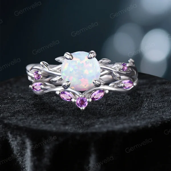 Frontal view of a nature-inspired bridal ring set featuring a fiery round cut Opal center stone with mesmerizing color play, surrounded by an intricate sterling silver twisting vine and leaf setting adorned with sparkling purple Amethyst gems.