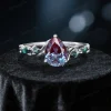 Front view of an antique noble engagement ring showcasing a pear cut alexandrite center stone.