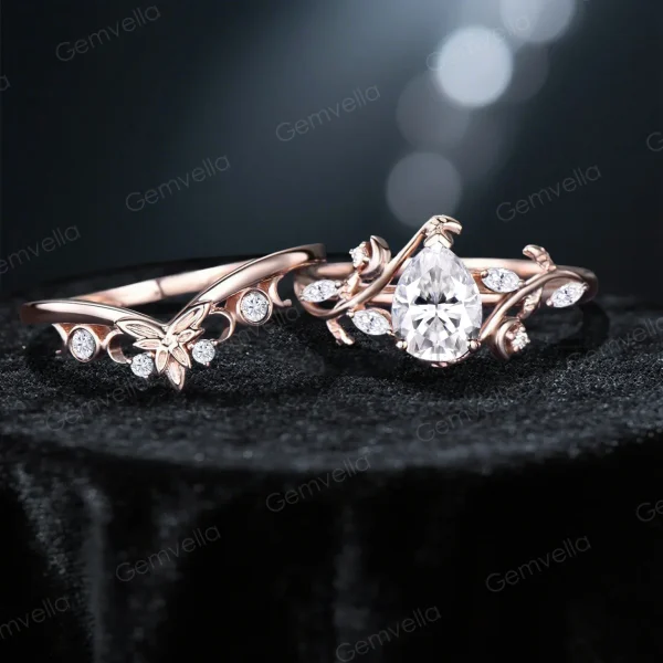 Flat lay photography of 14K rose gold moissanite ring set with pear cut center stone, stars moon and leaf vine details, nature bridal engagement ring styled on neutral background