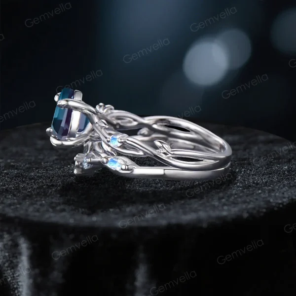Side profile showcasing the substantial width of the sterling silver band, the raised cathedral setting of the Alexandrite, and the detailed leaf texture wrapping around the side of the ring shank.