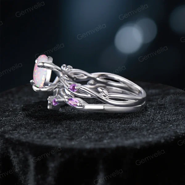 Side profile showcasing the substantial width of the sterling silver band, the raised cathedral setting of the Opal, and the detailed leaf texture wrapping around the side of the ring shank with embedded Amethyst stones.