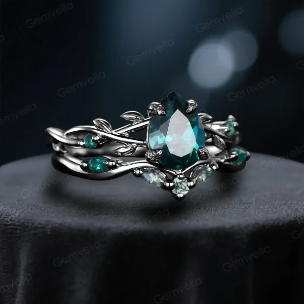 Angled perspective of the black gold engagement ring set with 1.25ct pear emerald and moss agate, displaying the gothic twig vine design from a three-quarter angle.