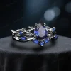 Angled perspective of the black gold engagement ring set with 1.25ct pear blue sapphire, displaying the gothic twig vine design from a three-quarter angle.