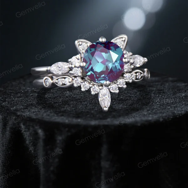 Angled perspective of the round cut alexandrite and moissanite cat ring, showing the depth of the white gold setting and the sparkle of the gemstones.