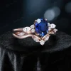 Side profile showing the height and detailed cluster setting of the oval Blue Sapphire and moissanite wedding set.