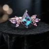 Angled view of art deco kite alexandrite and marquise amethyst cluster ring in 14k rose gold showing 3D perspective.