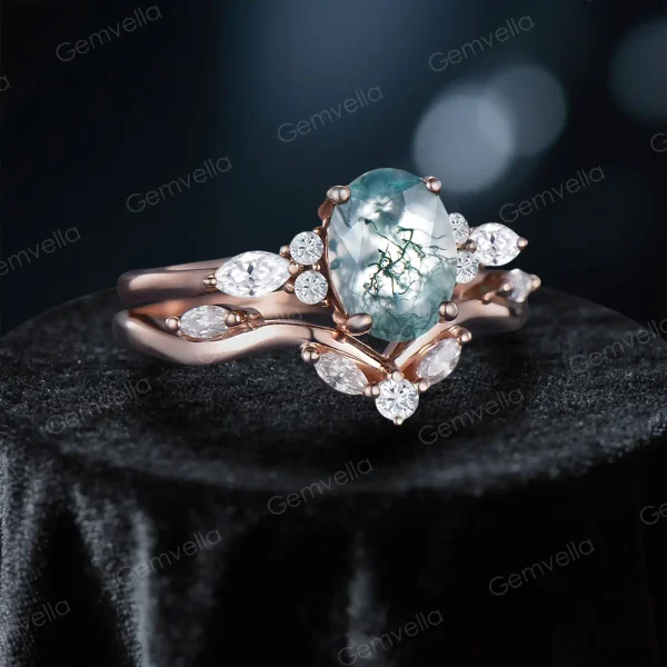 Side profile showing the height and detailed cluster setting of the oval moss agate and moissanite wedding set.