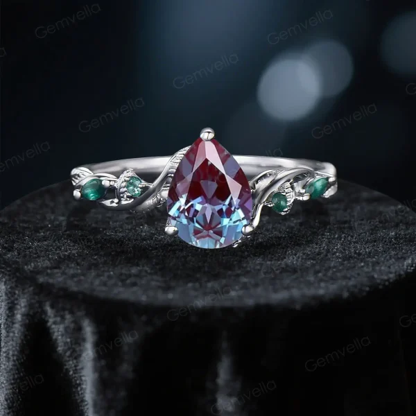 Front view of an antique noble engagement ring showcasing a pear cut alexandrite center stone.