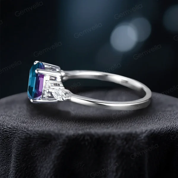 Side view highlighting the low-profile setting and intricate vintage engraving on the band of the 1.5ct oval alexandrite and marquise moissanite engagement ring.