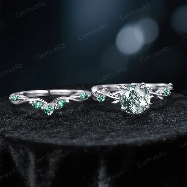 Flat lay photography of the two-piece ring set separated to show the detailed craftsmanship of the matching bands, highlighting the organic leaf patterns on both the engagement ring and the accompanying wedding band set with Emeralds.