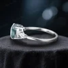 Side profile of the 1.5ct moss agate and moissanite ring, displaying the detailed band structure and secure setting for the oval moss agate center stone.