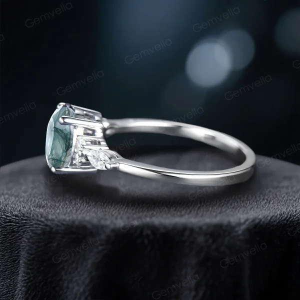 Side profile of the 1.5ct moss agate and moissanite ring, displaying the detailed band structure and secure setting for the oval moss agate center stone.