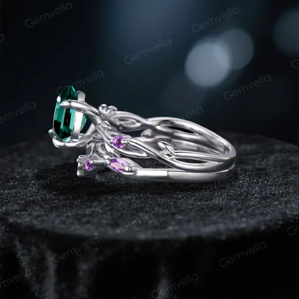 Side profile showing the intricate twisting vine leaf band and the gallery height of the 1.2ct round green emerald engagement ring.