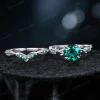 Flat lay photography of the 1.2ct round cut green emerald ring showing the full circumference of the twisting vine band.