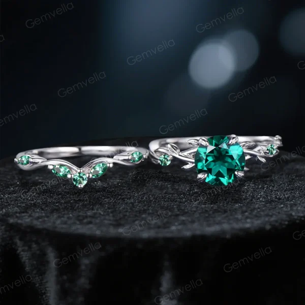 Flat lay photography of the 1.2ct round cut green emerald ring showing the full circumference of the twisting vine band.
