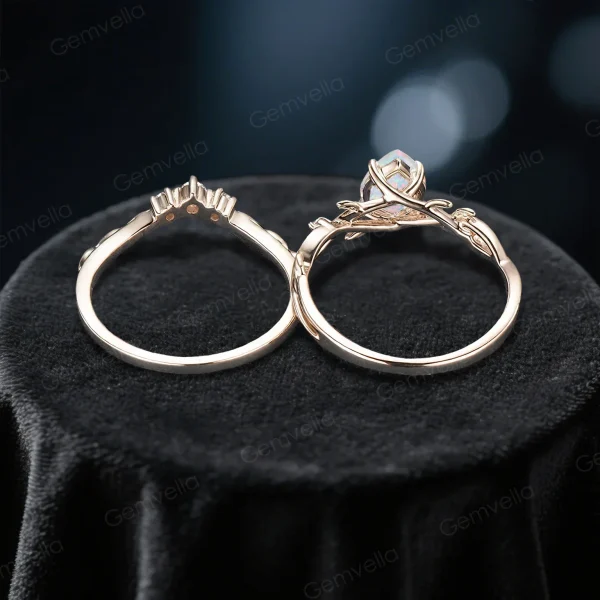 Overhead shot of the nature inspired opal bridal set displaying the intricate twig design, the width and thickness of the yellow gold band, and the brilliance of the pear shaped gemstone.