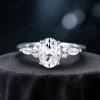 Front view of a 1.5ct oval cut moissanite engagement ring featuring a central stone flanked by marquise moissanite accents, showcasing a vintage nature-inspired design.