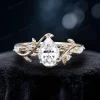1.25 carat pear-shaped moissanite bypass engagement ring crafted in 14K yellow gold, featuring the same nature-inspired leaf and vine branch design as the rose gold version, showcasing the warm golden tones and brilliant moissanite stone.