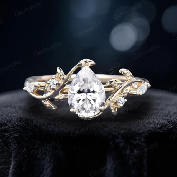 1.25 carat pear-shaped moissanite bypass engagement ring crafted in 14K yellow gold, featuring the same nature-inspired leaf and vine branch design as the rose gold version, showcasing the warm golden tones and brilliant moissanite stone.