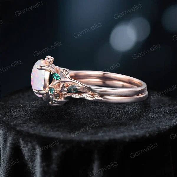 Side profile of a 10K rose gold nature-inspired engagement ring, showcasing the curved leaf vine branch band, 1.5ct oval white opal center stone height, and emerald and moss agate side accents