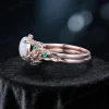 Side profile of 10K rose gold leaf vine branch engagement ring, highlighting the detailed band design and emerald accents alongside the central opal stone in nature inspired bridal set
