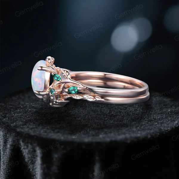 Side profile of 10K rose gold leaf vine branch engagement ring, highlighting the detailed band design and emerald accents alongside the central opal stone in nature inspired bridal set